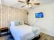 Bedroom featuring a ceiling fan, television, and a light wood accent wall at 1887 Springtime Ave, Clearwater, FL 33755