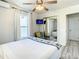 Bright bedroom with a ceiling fan and a built-in closet with a mirrored door at 1887 Springtime Ave, Clearwater, FL 33755
