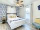 Inviting bedroom with patterned accent wall, ceiling fan and a bright window at 1887 Springtime Ave, Clearwater, FL 33755