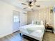 Bedroom featuring an exterior door and light wood accent wall at 1887 Springtime Ave, Clearwater, FL 33755
