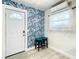 Welcoming entryway features stylish blue wallpaper, modern light fixtures, and vinyl floors at 1887 Springtime Ave, Clearwater, FL 33755
