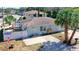 Aerial view of a light blue single-story home with a white fence and above ground pool at 1887 Springtime Ave, Clearwater, FL 33755