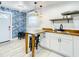 Modern kitchen area with butcher block countertops, white cabinets, and stylish hanging lights at 1887 Springtime Ave, Clearwater, FL 33755