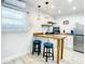 Modern kitchen features butcher block countertops, white cabinetry and stainless steel appliances at 1887 Springtime Ave, Clearwater, FL 33755