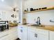Modern kitchenette with white cabinetry, a butcher block countertop, and view to the living room at 1887 Springtime Ave, Clearwater, FL 33755