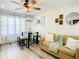 Inviting living room featuring light wood-look floors, comfortable seating, and stylish wall decor at 1887 Springtime Ave, Clearwater, FL 33755