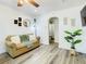 A comfortable living room featuring a sofa, decorative elements, and light wood-look flooring at 1887 Springtime Ave, Clearwater, FL 33755