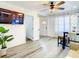Open living room with a TV, modern flooring, and a small table with chairs at 1887 Springtime Ave, Clearwater, FL 33755