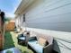 Relaxing backyard patio featuring artificial grass and comfortable wicker furniture at 1887 Springtime Ave, Clearwater, FL 33755