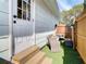 Cozy outdoor patio with outdoor seating, artificial grass, and a privacy fence at 1887 Springtime Ave, Clearwater, FL 33755