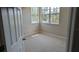 Cozy bedroom with neutral carpet, bright windows, and a freshly painted walls at 19251 Stone Hedge Dr, Tampa, FL 33647