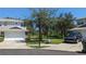 Well-maintained townhome with a two-car garage and a neatly landscaped front yard at 19251 Stone Hedge Dr, Tampa, FL 33647