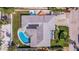 Aerial view of home with a fenced yard, pool, and thoughtfully designed landscaping for privacy at 2010 E Vina Del Mar Blvd, St Pete Beach, FL 33706