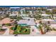 Aerial view of the home showcasing lush landscaping, fenced yard, boat parking, and neighborhood at 2010 E Vina Del Mar Blvd, St Pete Beach, FL 33706