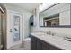 Updated bathroom with a marble countertop vanity, toilet, and walk-in shower view at 2010 E Vina Del Mar Blvd, St Pete Beach, FL 33706
