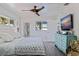 Bright bedroom featuring a ceiling fan, wood-look floors, and plenty of natural light at 2010 E Vina Del Mar Blvd, St Pete Beach, FL 33706