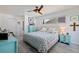 Comfortable bedroom with blue accents, a ceiling fan, and plenty of natural light at 2010 E Vina Del Mar Blvd, St Pete Beach, FL 33706