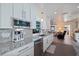 Bright kitchen with stainless steel appliances and granite countertops overlooking the open-concept living area at 2010 E Vina Del Mar Blvd, St Pete Beach, FL 33706