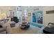Open-concept living room featuring direct access to the backyard, a ceiling fan, and an adjacent kitchen at 2010 E Vina Del Mar Blvd, St Pete Beach, FL 33706