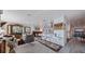 Open-concept living space with stylish decor, bar, wood floors, creating a warm and inviting atmosphere at 2010 E Vina Del Mar Blvd, St Pete Beach, FL 33706