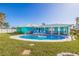 An inviting in-ground swimming pool is surrounded by a brick patio and comfortable seating in the backyard at 2010 E Vina Del Mar Blvd, St Pete Beach, FL 33706