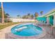 Inviting backyard pool with a pristine pool, poolside chairs, and surrounding tropical foliage at 2010 E Vina Del Mar Blvd, St Pete Beach, FL 33706