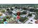 Aerial view of a residential neighborhood showcasing lush greenery and a swimming pool in the backyard at 2209 Kingswood Ln, Brandon, FL 33511