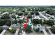 Aerial view of a residential neighborhood showcasing lush greenery and a swimming pool in the backyard at 2209 Kingswood Ln, Brandon, FL 33511
