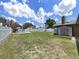 Large backyard with a well maintained lawn, white fence, and a storage shed at 2209 Kingswood Ln, Brandon, FL 33511