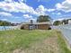 Large backyard with a well maintained lawn, white fence and partial view of the swimming pool at 2209 Kingswood Ln, Brandon, FL 33511