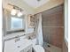 Bathroom features a tiled walk-in shower, neutral tones, and vanity with framed mirror at 2209 Kingswood Ln, Brandon, FL 33511