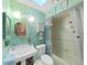 Bathroom features a pedestal sink, framed mirror, and aqua painted walls at 2209 Kingswood Ln, Brandon, FL 33511