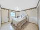 Cozy bedroom with tile floors, a canopy bed, and soft lighting for a peaceful retreat at 2209 Kingswood Ln, Brandon, FL 33511