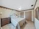 Comfortable bedroom with tile flooring, ceiling fan, and a cozy canopy bed with decorative pillows at 2209 Kingswood Ln, Brandon, FL 33511