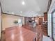 Open dining area with kitchen view, features wood floors and natural light from adjacent doorway at 2209 Kingswood Ln, Brandon, FL 33511