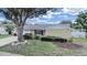 Charming single-story home with a well-manicured lawn and mature landscaping at 2209 Kingswood Ln, Brandon, FL 33511