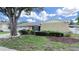 Charming single-story home with a well-manicured lawn and mature landscaping at 2209 Kingswood Ln, Brandon, FL 33511