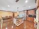 Open-concept kitchen featuring a central island with seating, stainless steel appliances, and a view of the dining area at 2209 Kingswood Ln, Brandon, FL 33511