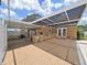 Outdoor kitchen and bar under a covered patio and brick flooring at 2209 Kingswood Ln, Brandon, FL 33511