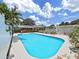 Fenced in backyard pool with an outdoor kitchen and covered patio area at 2209 Kingswood Ln, Brandon, FL 33511