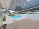 A fenced in backyard with a beautiful private pool and a covered patio with brick flooring at 2209 Kingswood Ln, Brandon, FL 33511
