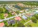 Wide aerial view of a community featuring multiple homes, landscaping, a lake, and a golf course at 2221 Platinum Dr, Sun City Center, FL 33573