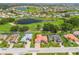 Aerial view showcasing an inviting home with lush landscaping in a community with lake and golf course views at 2221 Platinum Dr, Sun City Center, FL 33573