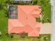 Aerial view of a home showcasing the roof, screened lanai, and well-maintained landscaping at 2221 Platinum Dr, Sun City Center, FL 33573