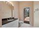 Neutral bathroom with a granite vanity and direct access to a screened-in patio at 2221 Platinum Dr, Sun City Center, FL 33573