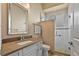 Bathroom featuring a tiled shower with glass door and quartz vanity at 2221 Platinum Dr, Sun City Center, FL 33573