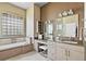 Spacious bathroom with a soaking tub and vanity area at 2221 Platinum Dr, Sun City Center, FL 33573