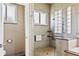 Modern bathroom featuring a frameless glass shower and tiled walls at 2221 Platinum Dr, Sun City Center, FL 33573