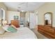 Bedroom with neutral colors, ceiling fan, and en suite bathroom at 2221 Platinum Dr, Sun City Center, FL 33573