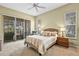 Calm bedroom with a sliding glass door to a patio and neutral décor at 2221 Platinum Dr, Sun City Center, FL 33573